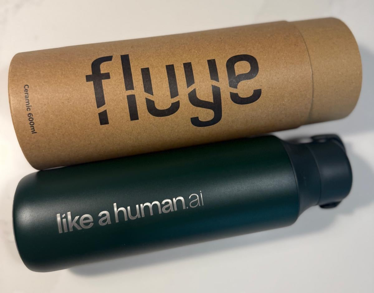Ampolla Fluye verda amb el logotip de Like a Human gravat, juntament amb el seu tub de cartó
